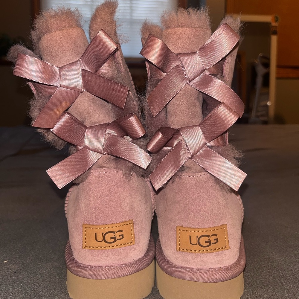Purple ugg boots with bows on the back